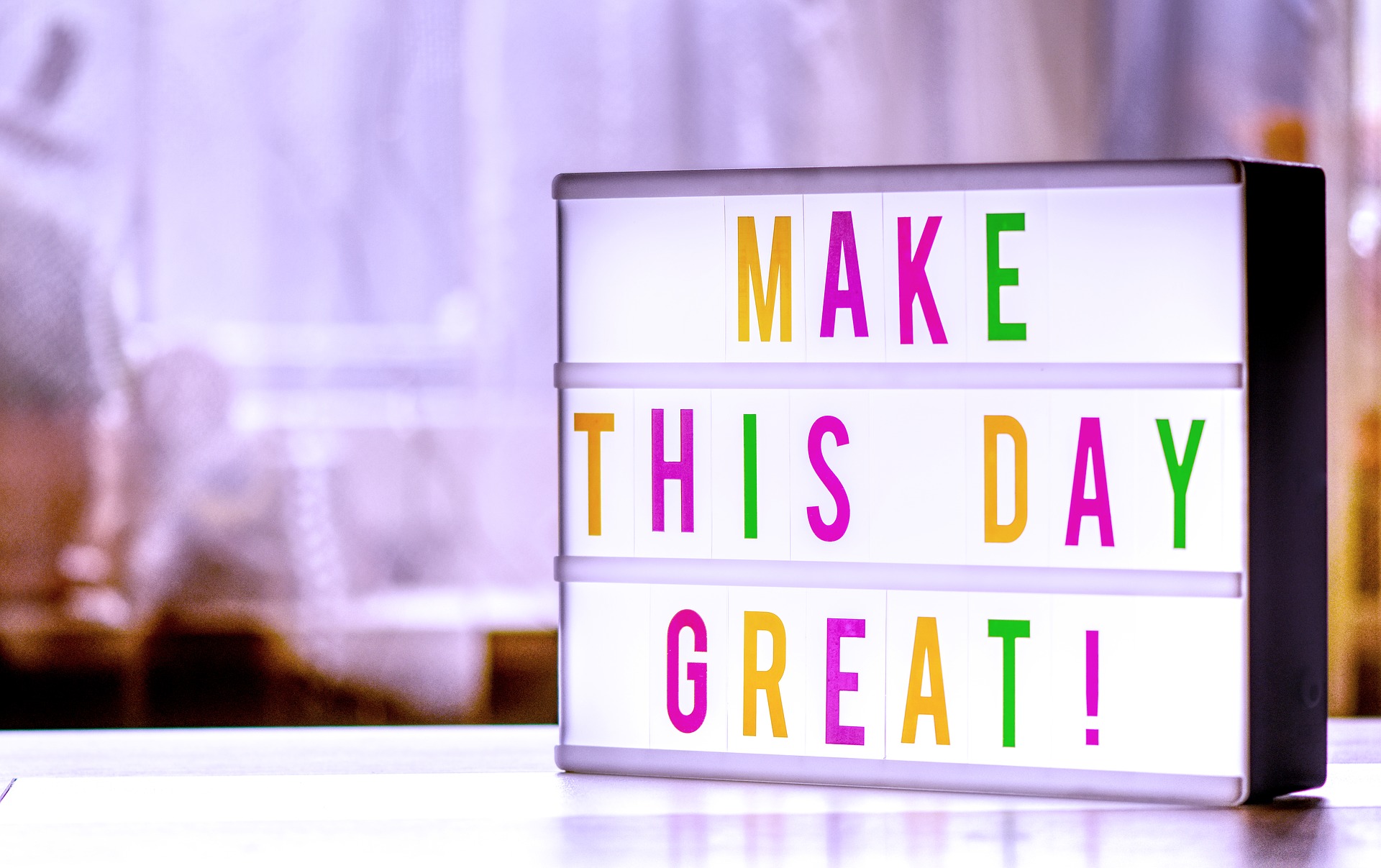 A bright motivational sign sitting on a desk