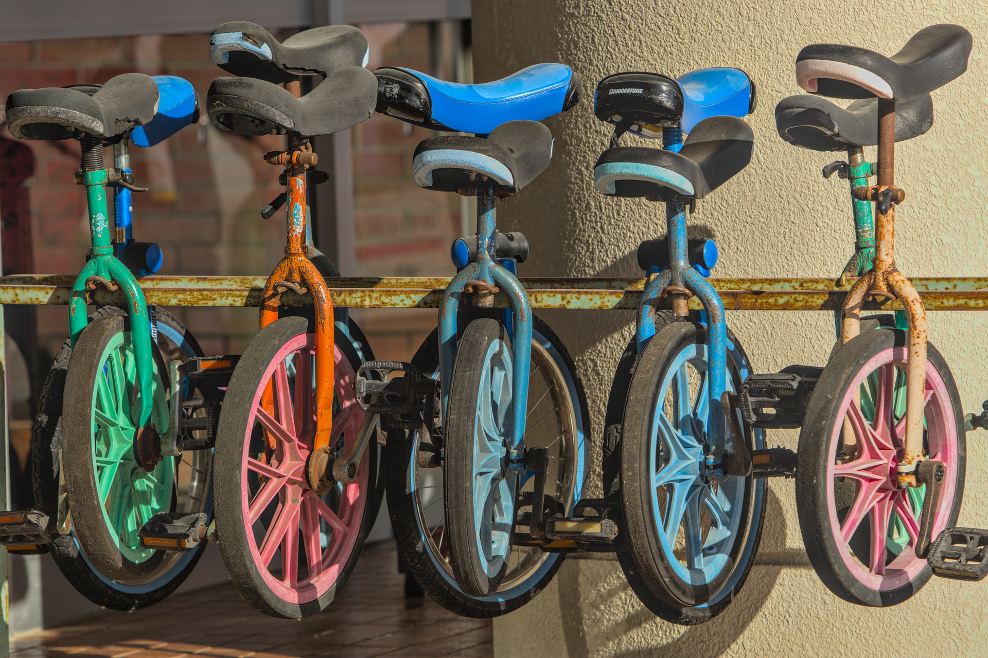 A row of different colored bycicles