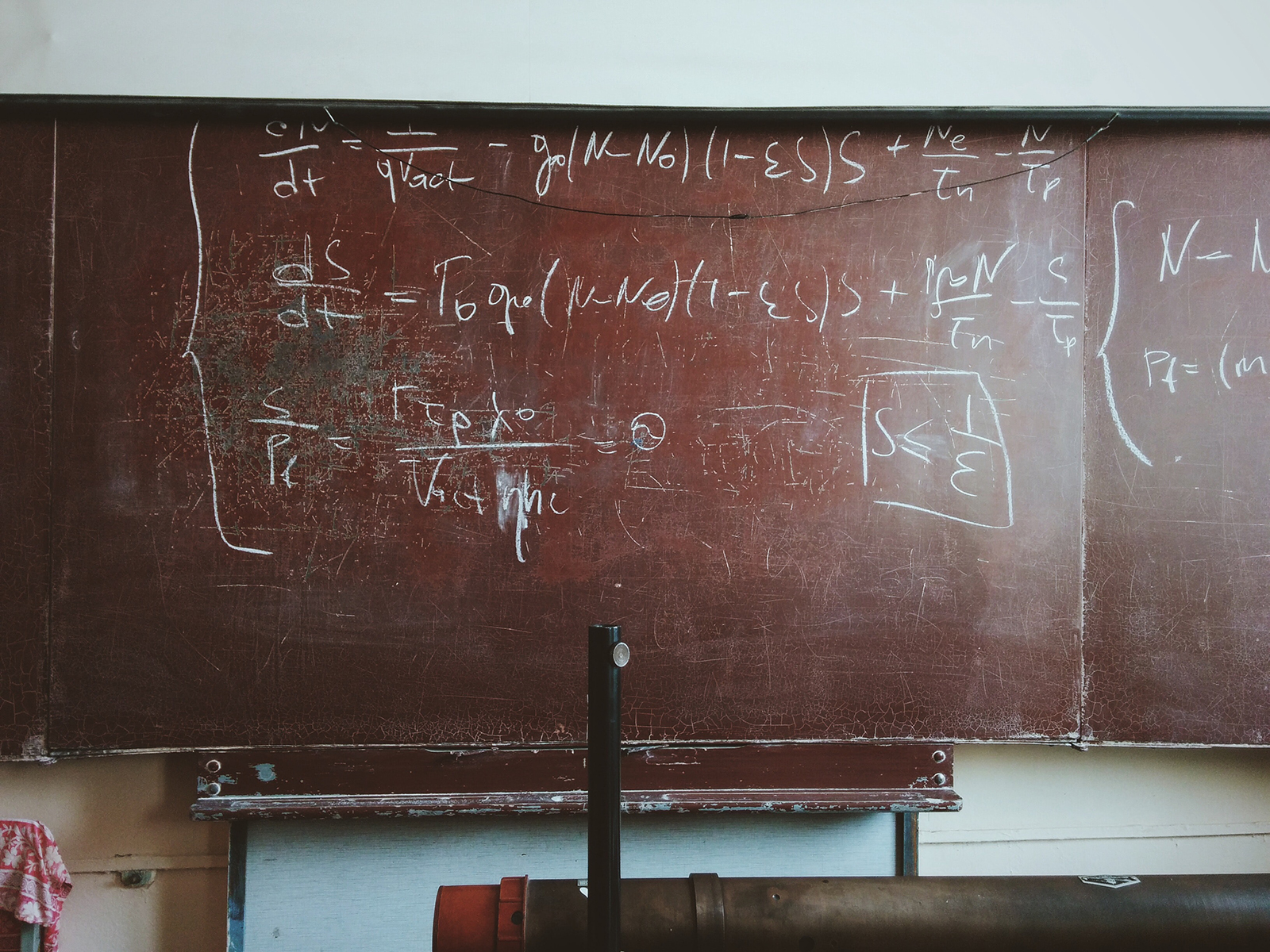 An equation written on a chalkboard.