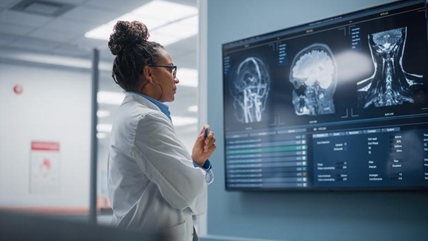 A doctor studies the scans of a human brain.