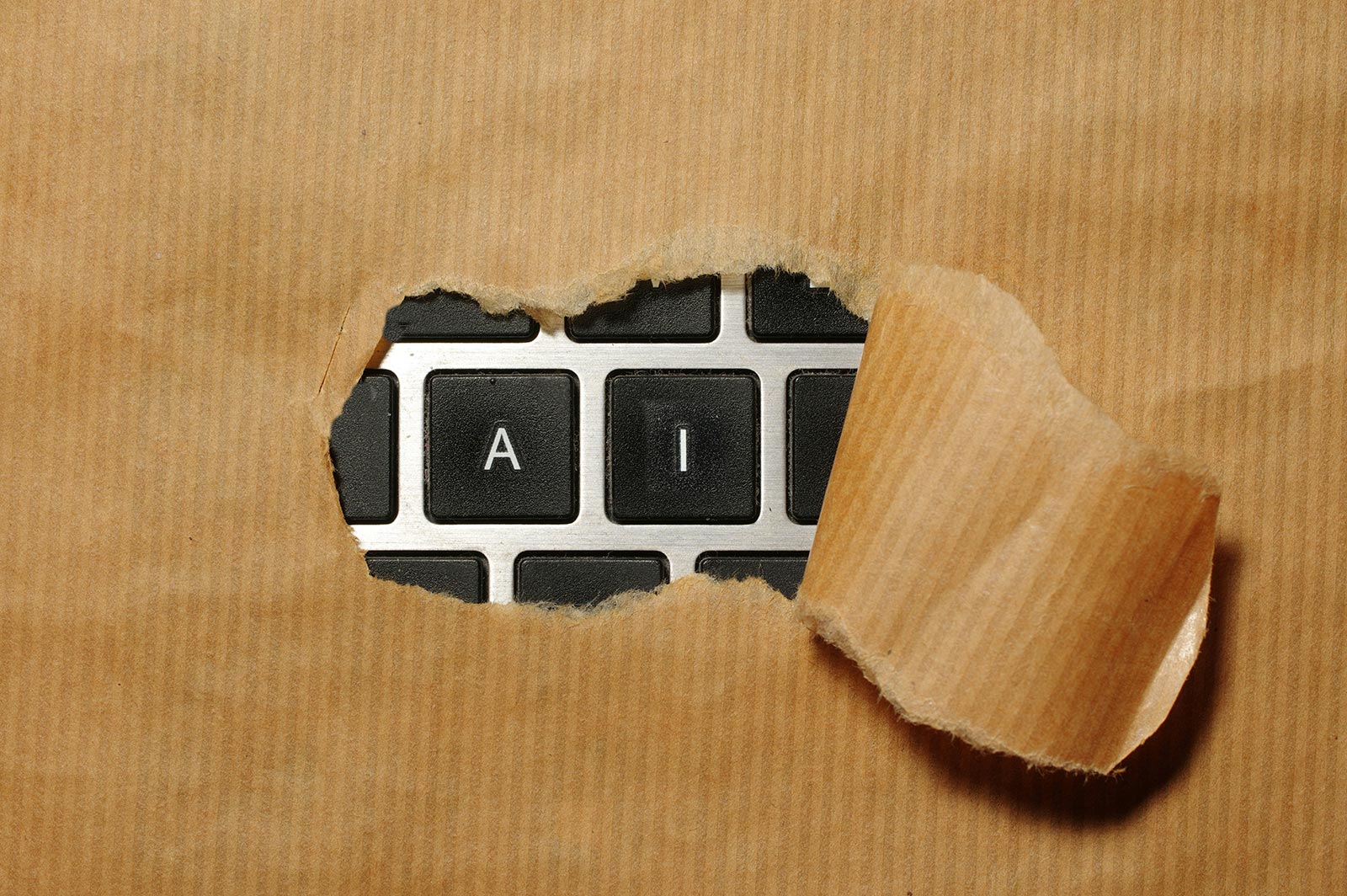 A computer keyboard with only A and I exposed behind a piece of paper.