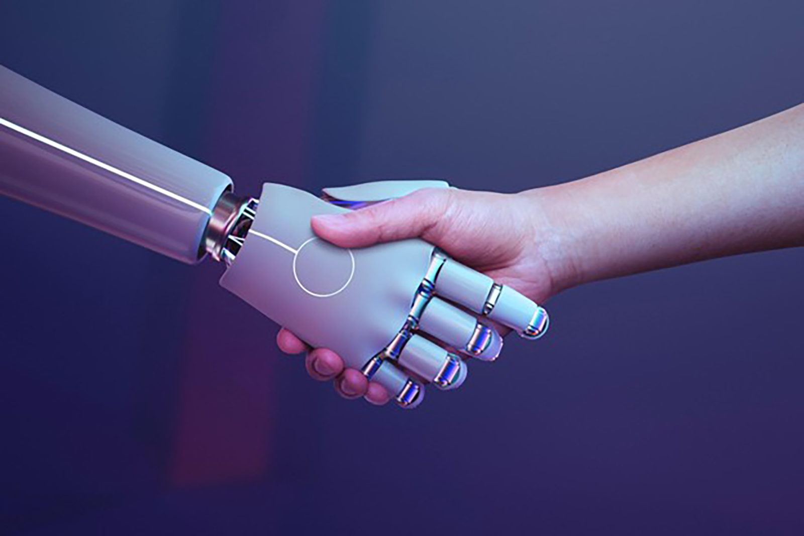 A robot hand and a human hand shake hands.