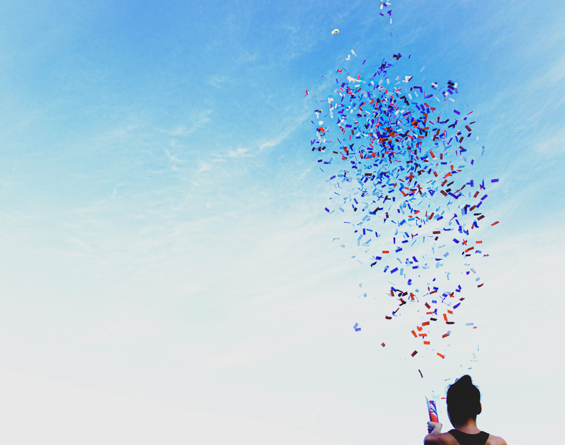Person shoots confetti up into the air.