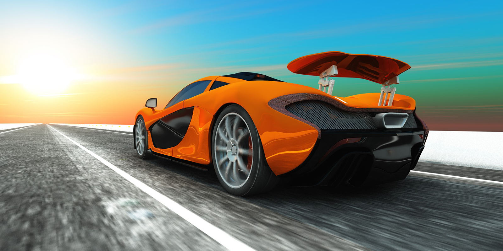 A rear shot of an orange sports car as it drives down a highway into the sunset.